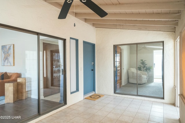 interior space with ceiling fan