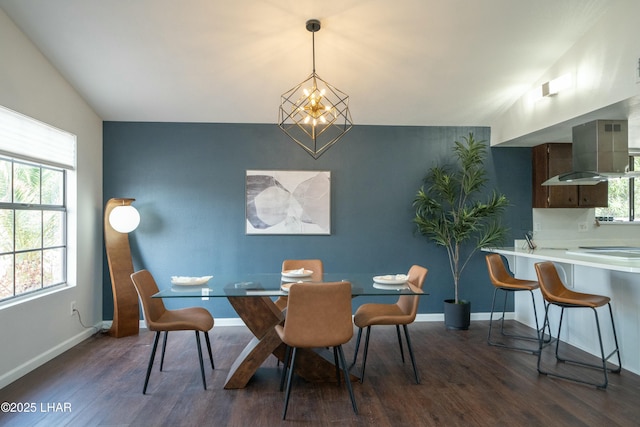 dining area featuring a wealth of natural light, lofted ceiling, baseboards, and wood finished floors