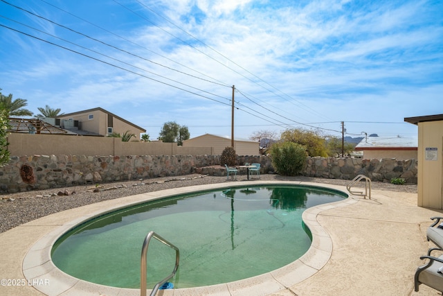 view of swimming pool featuring a patio, a fenced backyard, and a fenced in pool