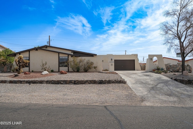 view of front of property with concrete driveway and stucco siding