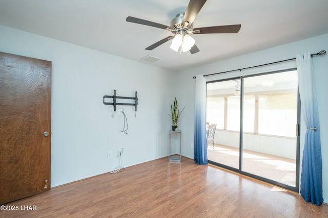 unfurnished room featuring ceiling fan, visible vents, and wood finished floors