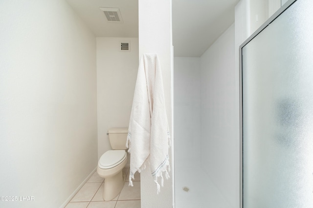 bathroom featuring toilet, a shower stall, visible vents, and tile patterned floors