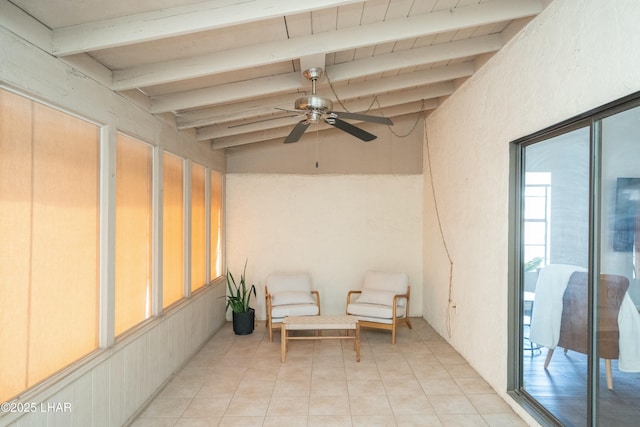 sunroom / solarium featuring lofted ceiling with beams and a ceiling fan