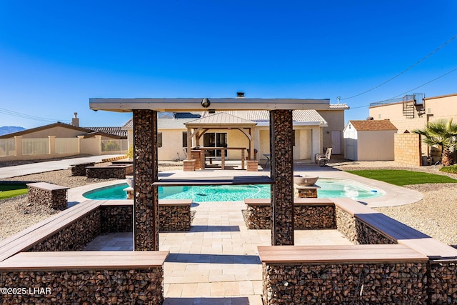 back of house with a pool with hot tub, a gazebo, and a patio area