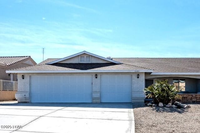 ranch-style house with concrete driveway, an attached garage, and stucco siding