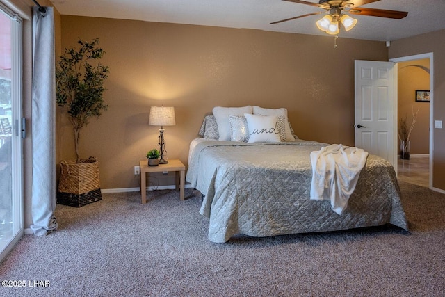 bedroom with a ceiling fan, carpet flooring, and baseboards