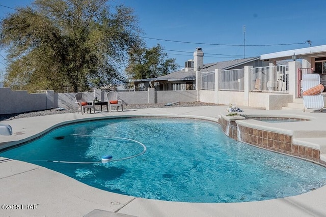 view of pool featuring an in ground hot tub, a patio area, a fenced backyard, and a fenced in pool