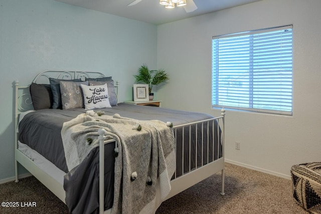 carpeted bedroom with ceiling fan and baseboards