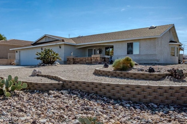 ranch-style home featuring concrete driveway, an attached garage, and stucco siding