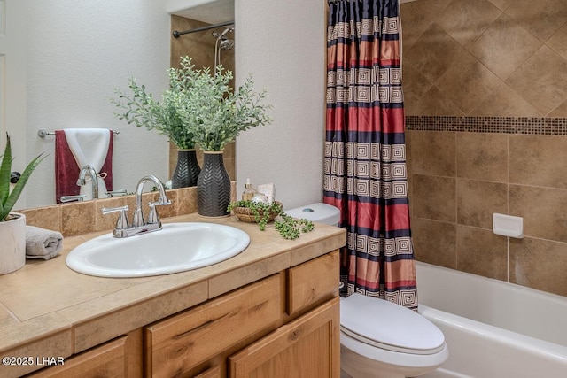 bathroom featuring toilet, a textured wall, shower / bath combination with curtain, and vanity