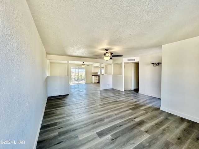 interior space featuring ceiling fan, hardwood / wood-style flooring, and a textured ceiling