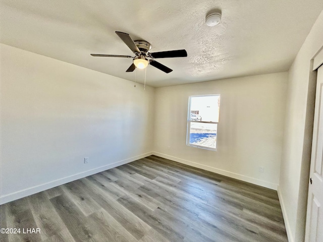 spare room featuring ceiling fan, wood-type flooring, and a textured ceiling