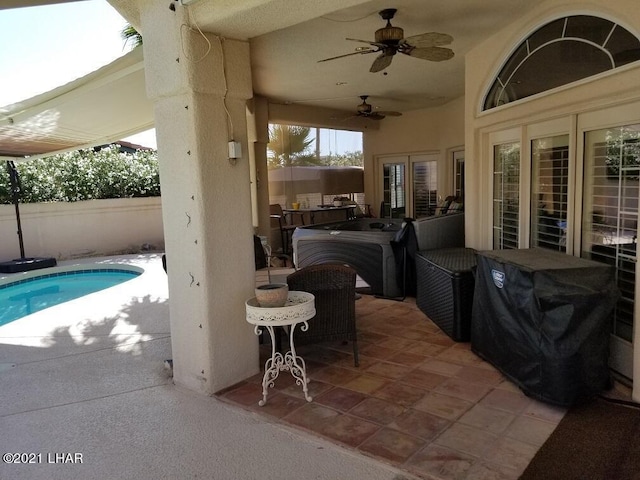 view of patio with ceiling fan and a fenced in pool