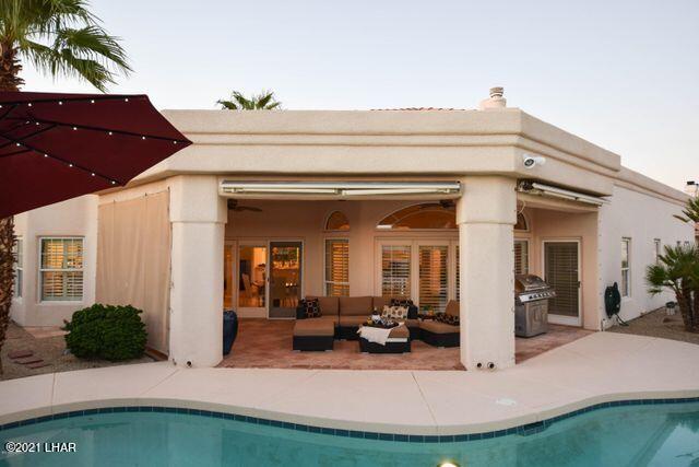 back of house with an outdoor hangout area and a patio area