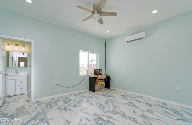 bedroom featuring a wall unit AC, recessed lighting, baseboards, and a sink