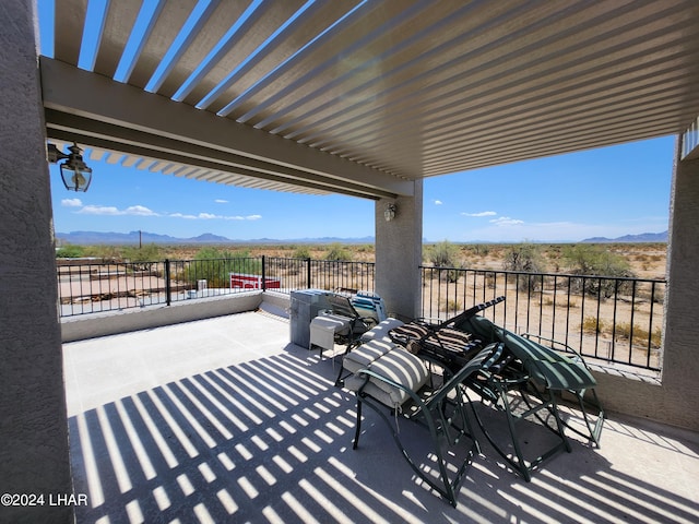 view of patio / terrace featuring a mountain view and a pergola