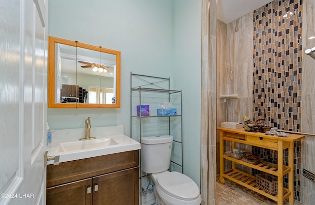 bathroom with vanity, toilet, and a ceiling fan