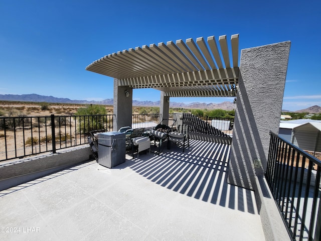 view of patio / terrace featuring a mountain view and a pergola