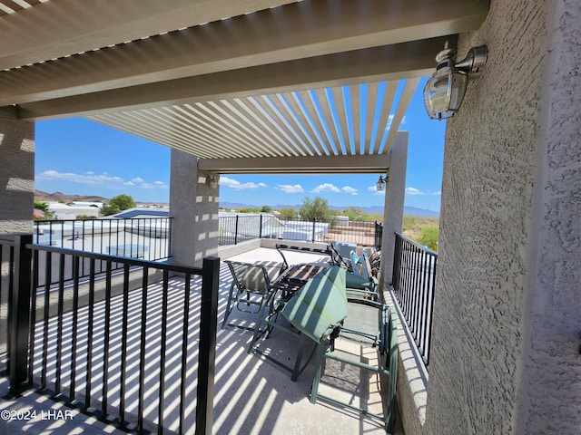 view of patio featuring a balcony