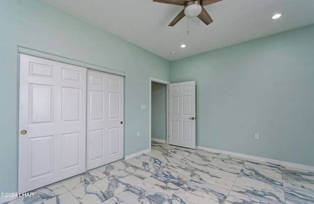 unfurnished bedroom featuring baseboards, recessed lighting, a closet, marble finish floor, and a ceiling fan