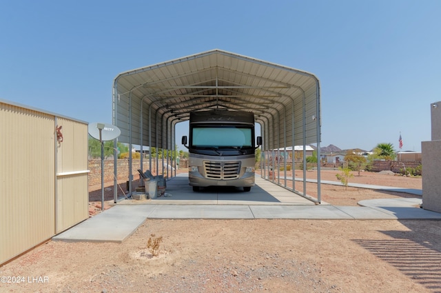 view of vehicle parking with a carport and driveway