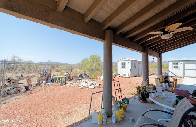 view of patio / terrace featuring a fenced backyard, an outdoor structure, and a shed