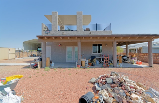 back of house featuring a patio area, stucco siding, and fence