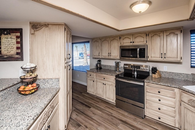 kitchen featuring dark hardwood / wood-style flooring, light brown cabinets, and appliances with stainless steel finishes