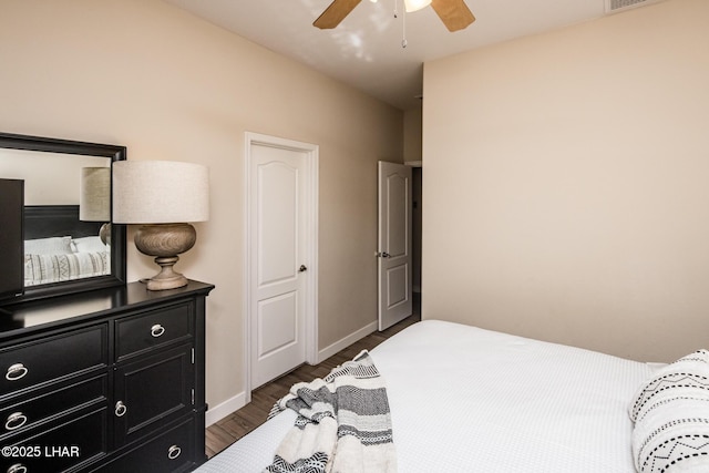 bedroom with ceiling fan and dark hardwood / wood-style floors