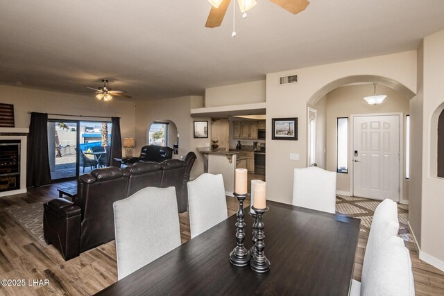 dining space with hardwood / wood-style flooring and ceiling fan