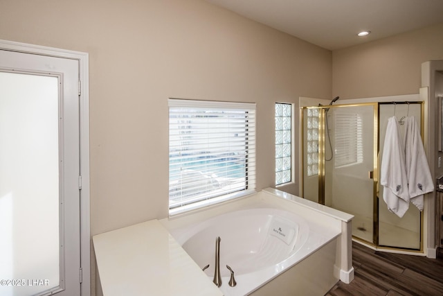 bathroom featuring hardwood / wood-style flooring and shower with separate bathtub