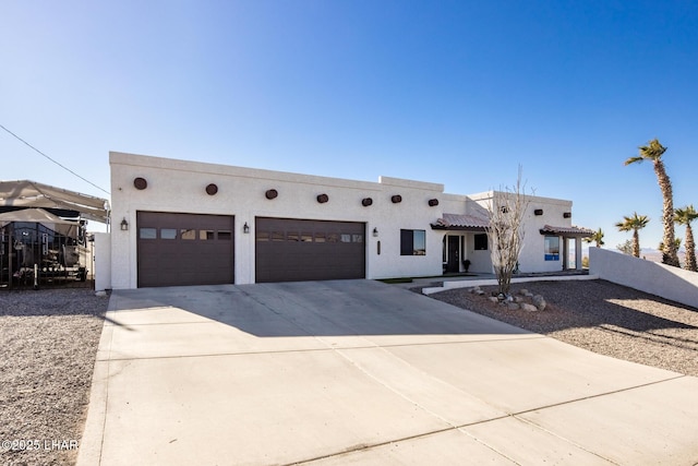 pueblo revival-style home with a garage