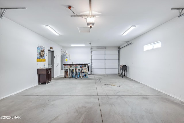 garage featuring electric water heater, a garage door opener, and baseboards