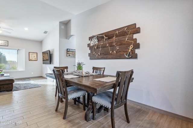 dining room featuring ceiling fan, visible vents, baseboards, and wood finished floors