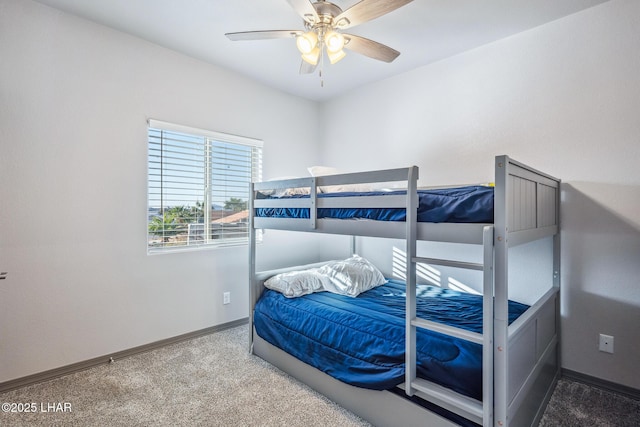 carpeted bedroom with baseboards and a ceiling fan