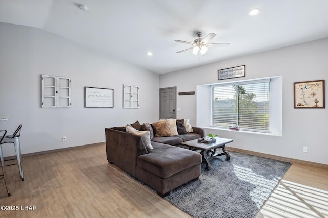 living area with recessed lighting, wood finished floors, baseboards, and vaulted ceiling