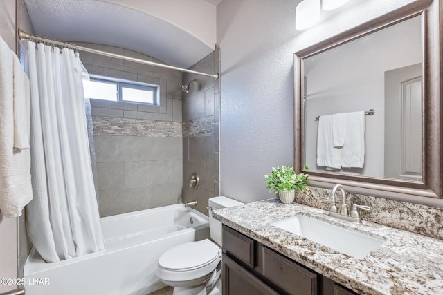 full bath featuring shower / bathtub combination with curtain, toilet, vanity, and a textured wall