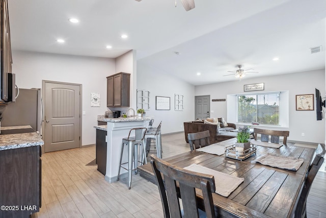 dining space with visible vents, lofted ceiling, recessed lighting, light wood-style floors, and a ceiling fan