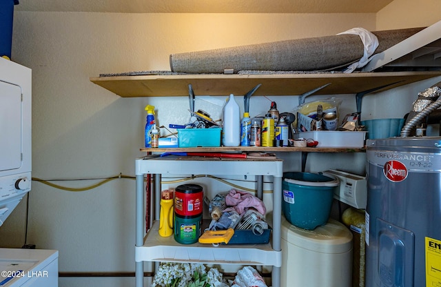 storage area with water heater and stacked washer / dryer