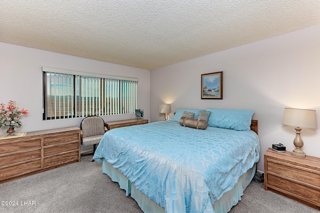 carpeted bedroom with a textured ceiling