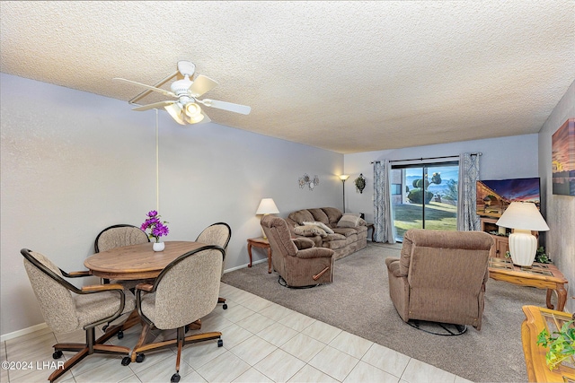 carpeted dining area with vaulted ceiling, ceiling fan, and a textured ceiling