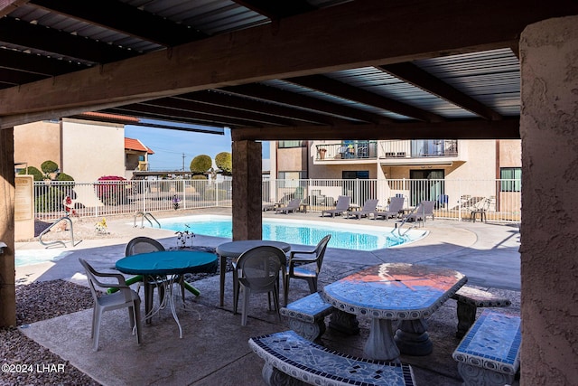 view of swimming pool featuring a patio area