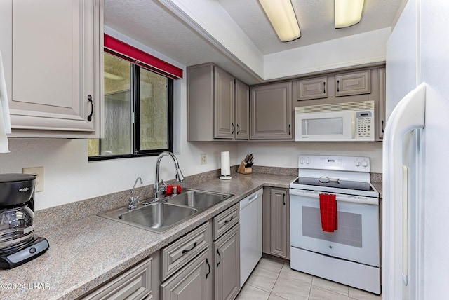 kitchen with sink, white appliances, gray cabinetry, a textured ceiling, and light tile patterned flooring