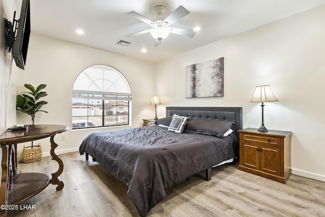 bedroom with ceiling fan and light hardwood / wood-style flooring