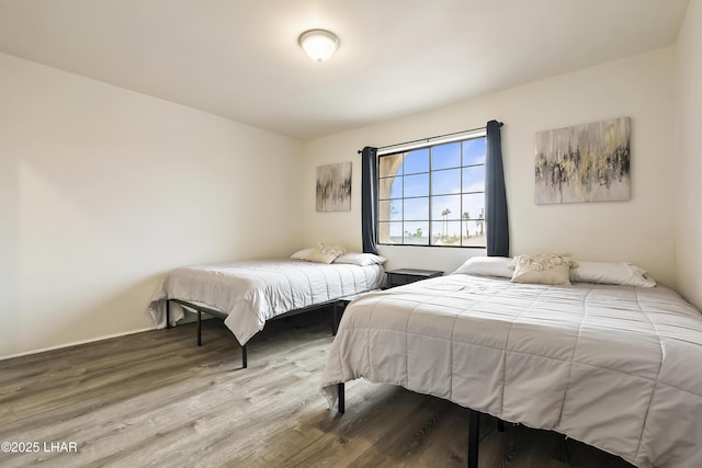 bedroom with hardwood / wood-style flooring