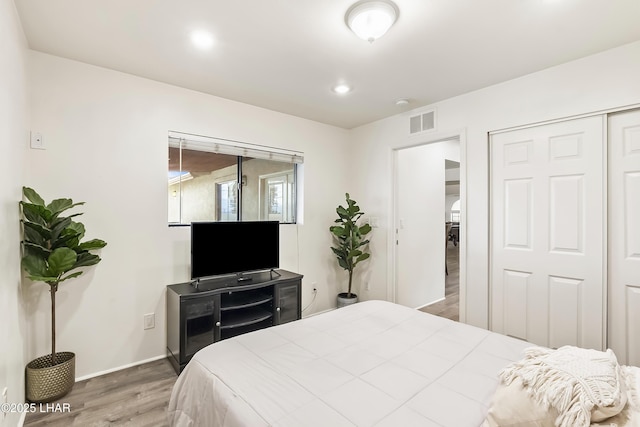 bedroom featuring hardwood / wood-style floors and a closet