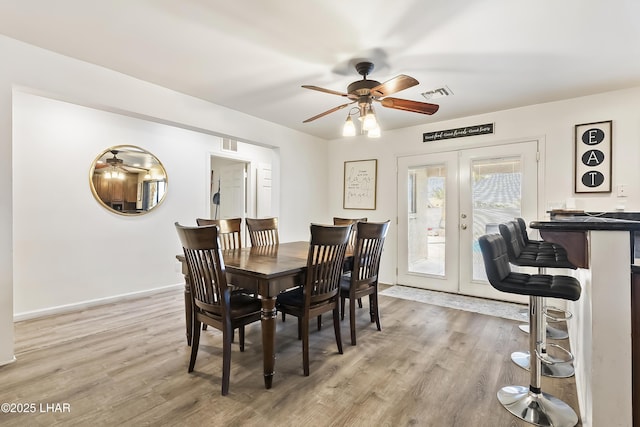 dining area featuring hardwood / wood-style floors, french doors, and ceiling fan