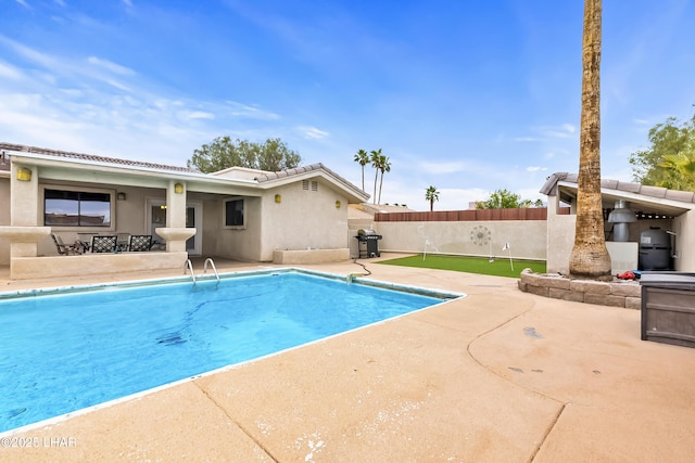 view of swimming pool featuring a patio and area for grilling