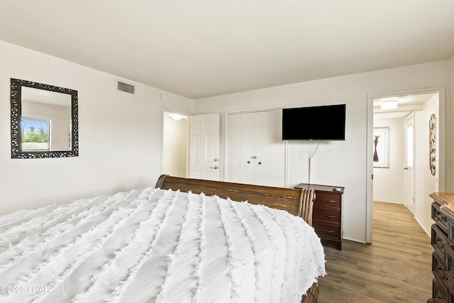 bedroom with a closet and light hardwood / wood-style flooring