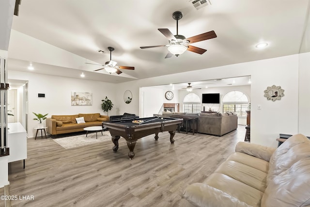 living room featuring lofted ceiling, light hardwood / wood-style floors, and billiards